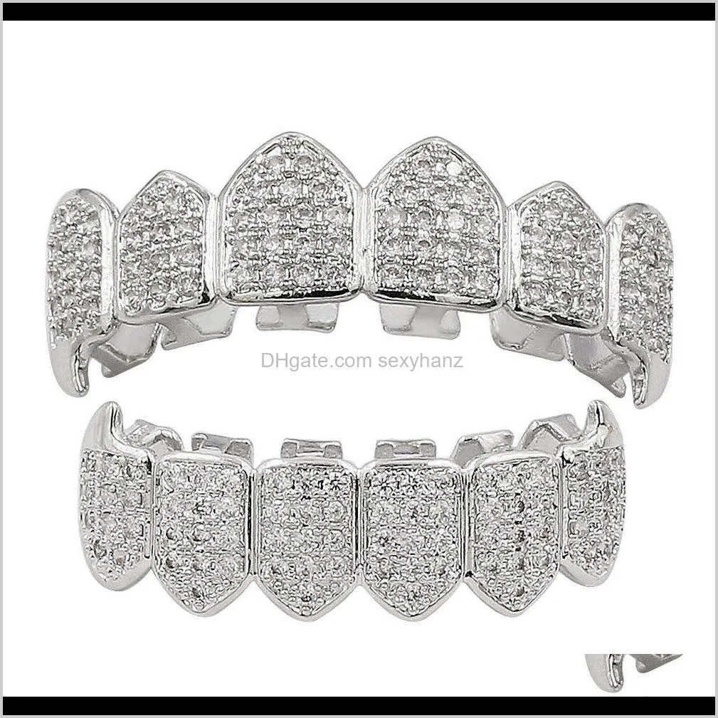 Grillz Body Drop Delivery 2021 Hip Hop Dental Grills Smycken Lyx Herr Dam Kvalitet Kvalitet Cubic Zirconia Asfalterad Vampyr Tänder Hängslen Gata