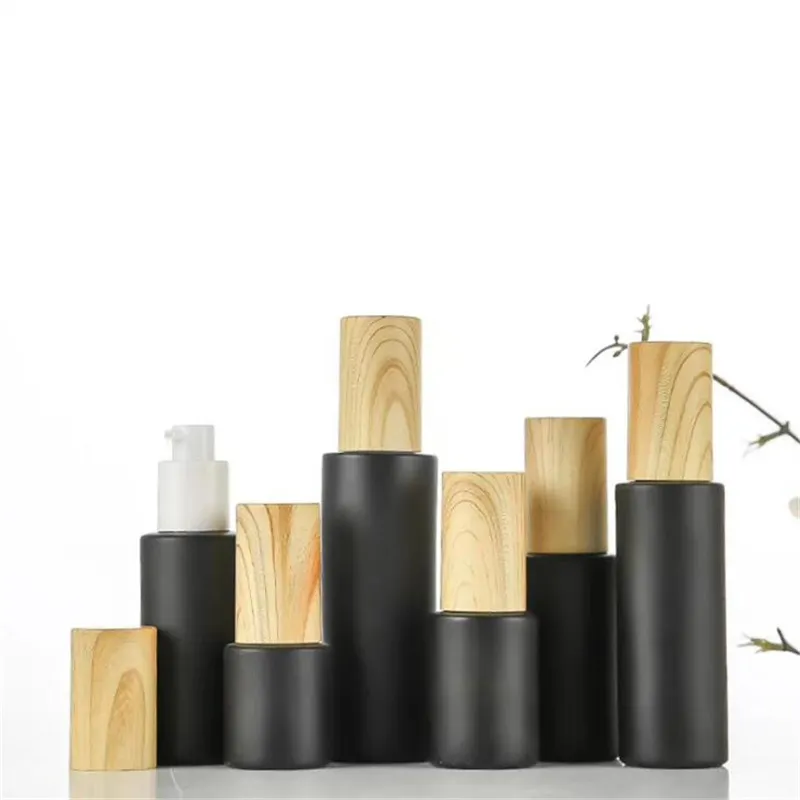 Bouteille cosmétique en verre dépoli noir pots de crème vides bouteilles de pompe de lotion de pulvérisation paquet de conteneur rechargeable avec bouchons en plastique à grain de bois