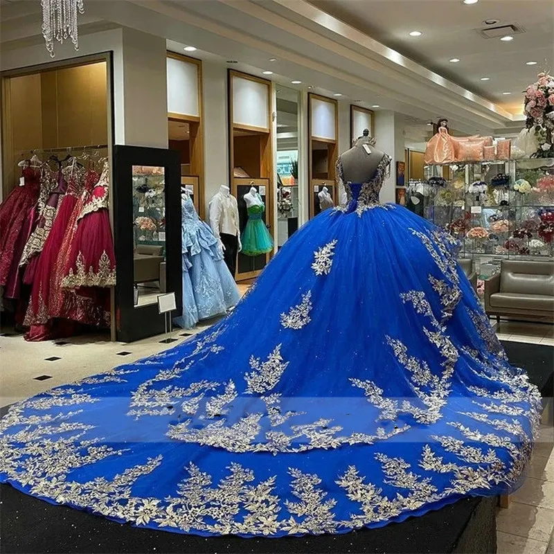 Sparkling Royal Blue Quinceanera Ball Blue Ball gown with Golden Appliques, Beads, and Puffy Train - Perfect for 15th Birthday Parties