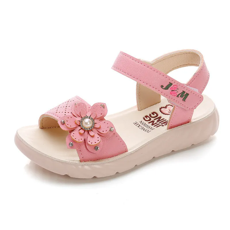 Premium Photo | Macro details pink childrens sandals on the girls feet of a  child sitting on a white poured background