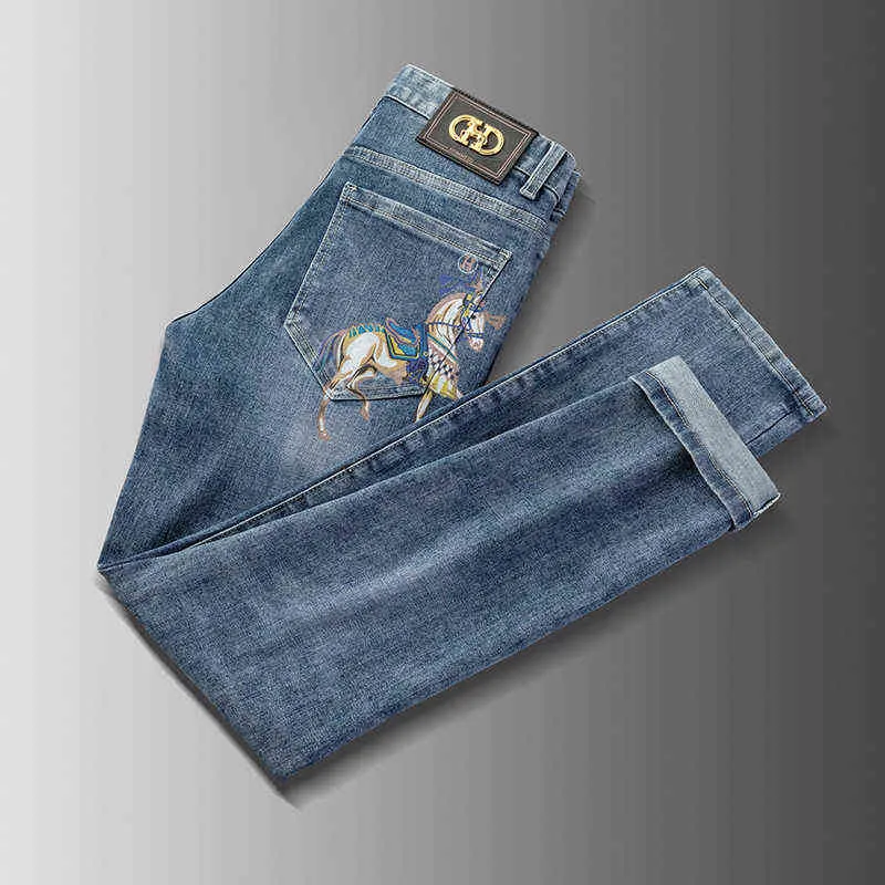 Designer Spring Summer Brand Jeans Men's Elastic Korean Version Slim Montering Feet Golden Horse Printed Blue Pant