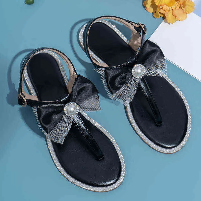 Tofflor glider kvinnor skor lyxiga pärlbåge strand sandaler sommar mode strass platt tofflor flip flops 220525