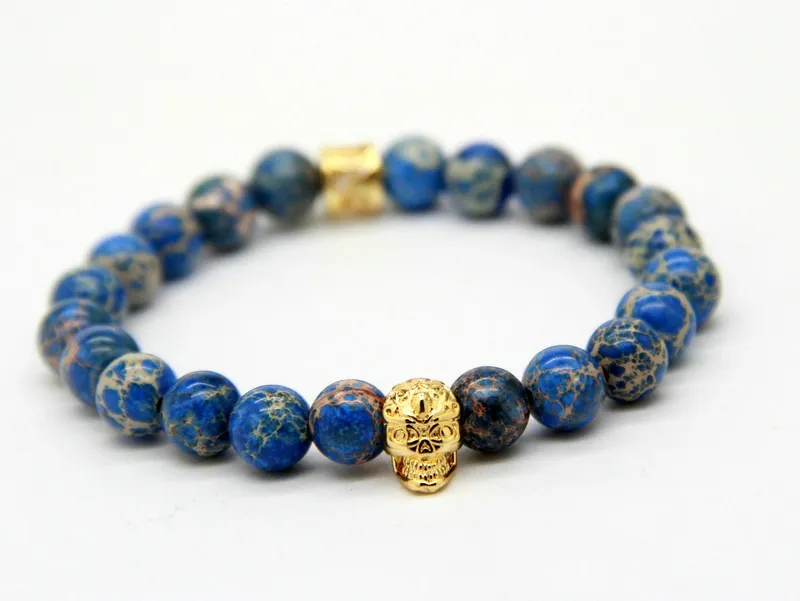 New Design High Grade Jewelry Wholesale 8mm Blue Sea Sediment Stone Bead with Bronze Gold and Silver Skull Bracelet