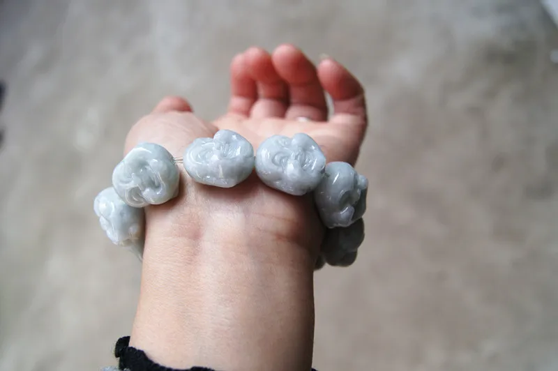 Hand carved jade Buddha, rubber band strings into a bracelet. A successful man's favorite