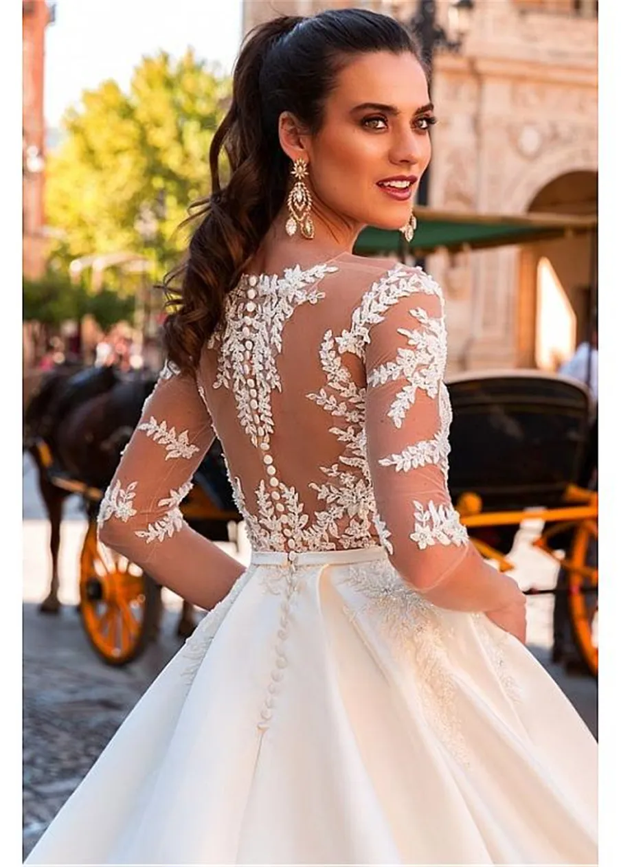 Increíble vestido de novia de una línea transparente con escote barco de satén de tul y apliques de encaje con cuentas Vestido de novia de manga larga transparente