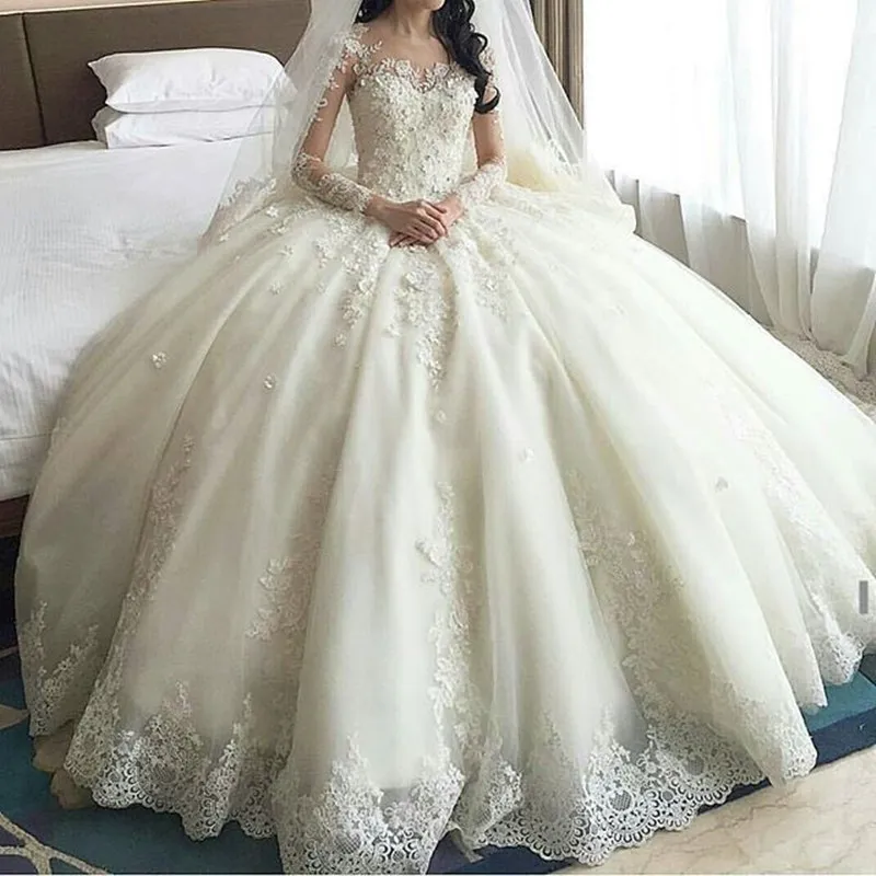 Prinsessan Lace Ball Gown Bröllopsklänning med Sheer Neck Illusion Långärmade Bröllopsklänningar Tillbaka Täckta Knappar Bridal Vestidos