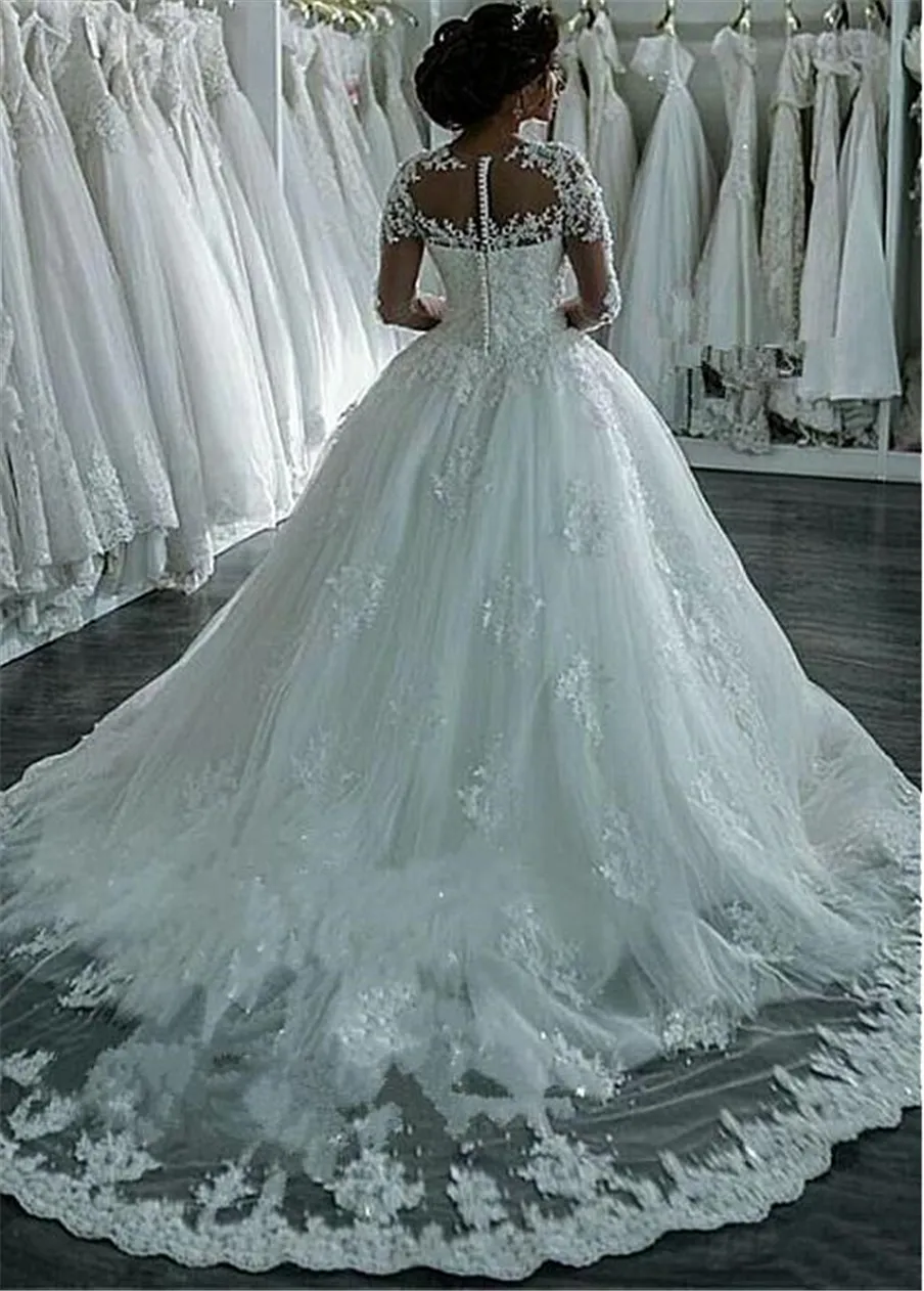 Incredibili abiti da sposa in tulle trasparente a maniche lunghe con scollo gioiello e abiti da sposa con applicazioni in pizzo con perline