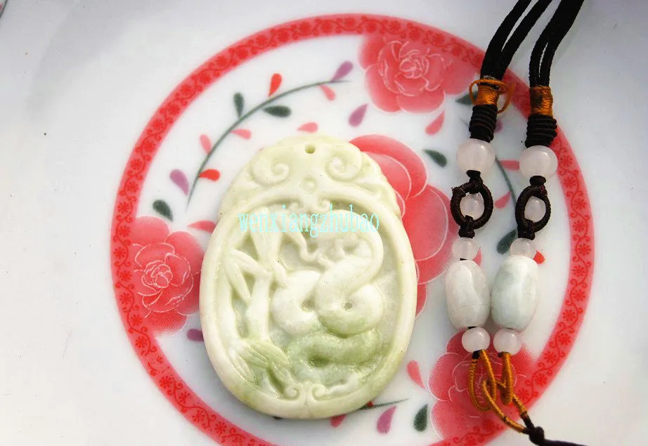 The natural white jade that is carved by hand. Silver snake dish bamboo rising up. Talisman necklace pendant