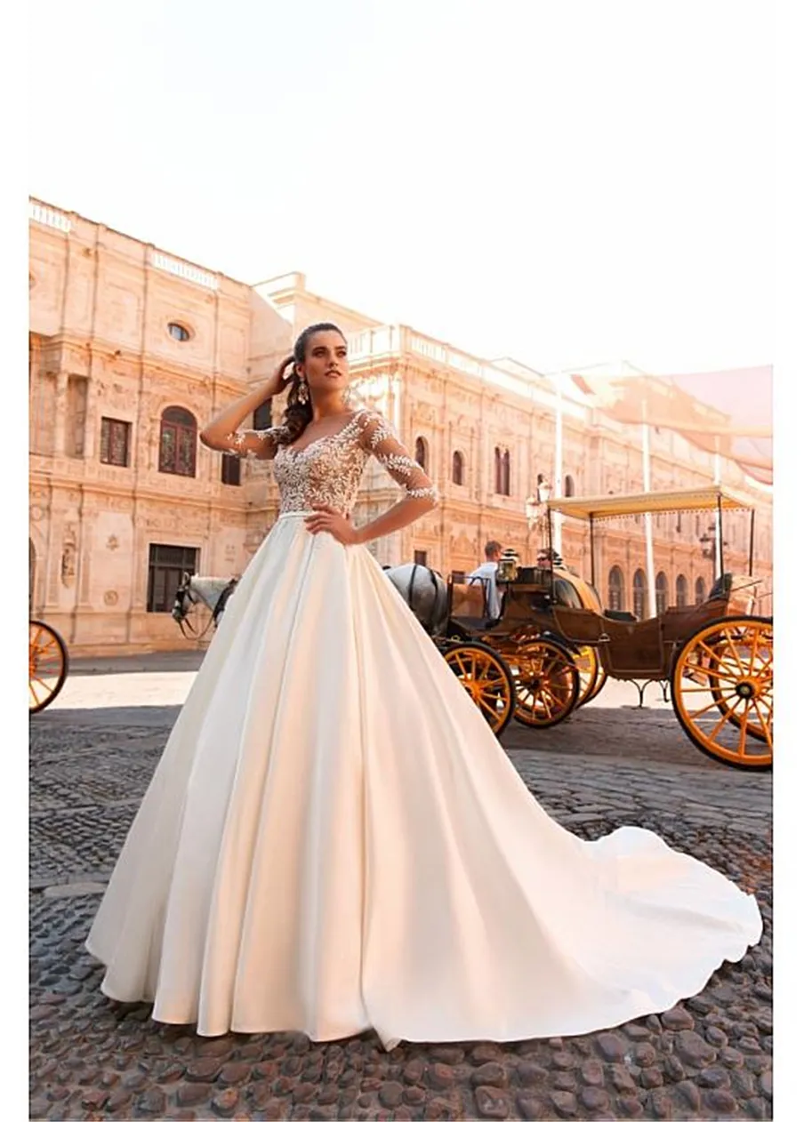 Increíble vestido de novia de una línea transparente con escote barco de satén de tul y apliques de encaje con cuentas Vestido de novia de manga larga transparente