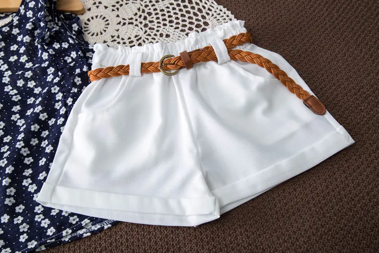 2018 Mädchen-Sommer-Outfits, ärmelloses T-Shirt mit Blumendruck + weiße Shorts, Hosen, 3-teiliges Set, Mädchen-Kleidungsset, Kinder-Outwear-Set mit Gürtel Boutique
