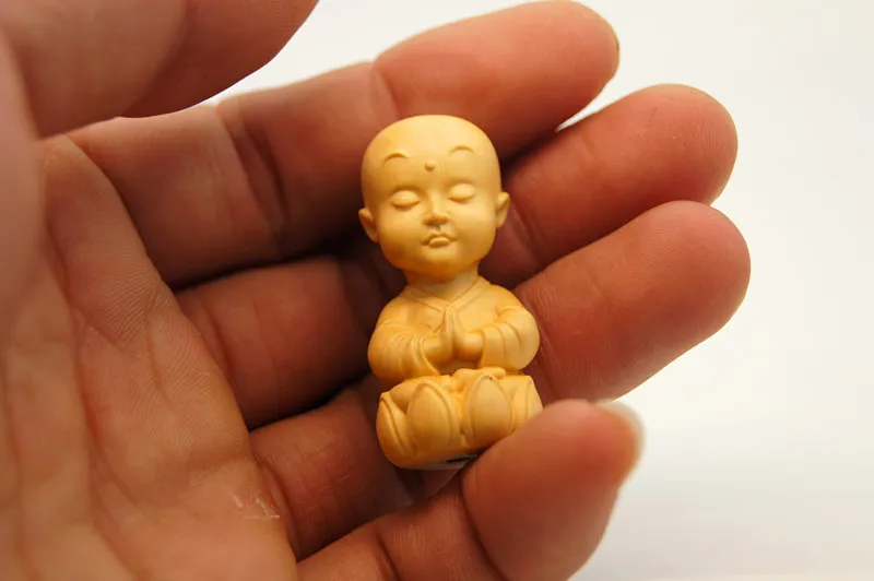 The yellow poplar wood hand-carved and carpeted, hanging - the Buddha. Talisman necklace pendant.