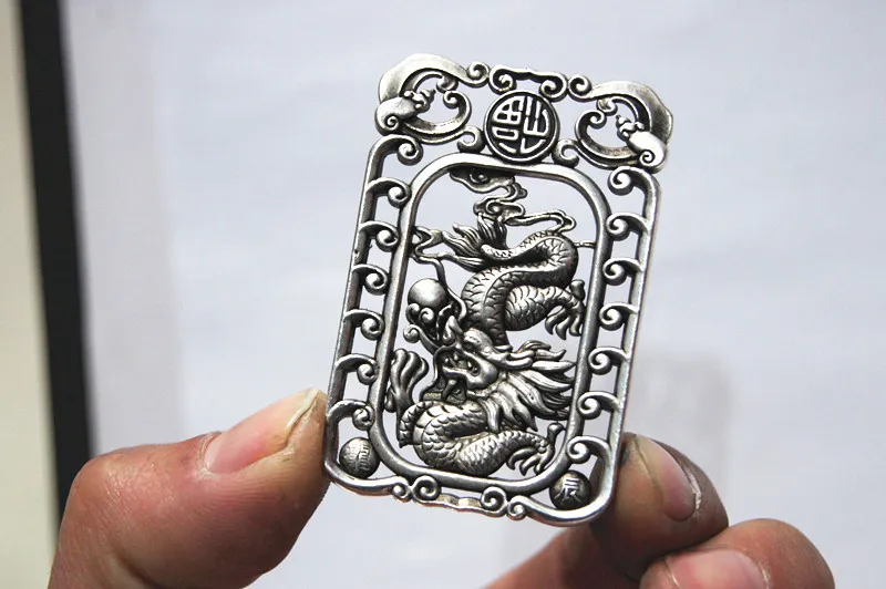 Antique white bronze double-sided dragon play ball (lucky word). Rectangular lucky necklace pendant.