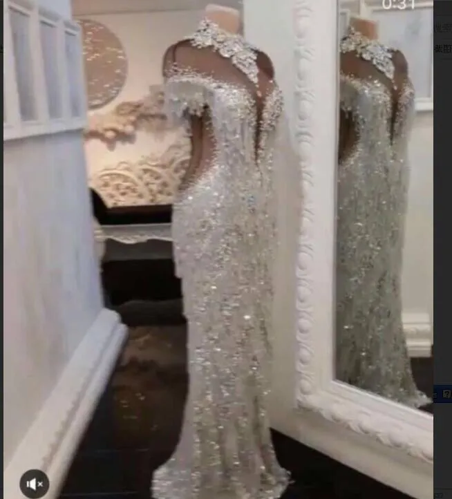 Aftonklänning YouSef Aljasmi Kim Kardashian Mermaid High Neck Tassels Short Sleeve BlackAlDa GiannyaAzar Zuhlair Murad Ziadnakad