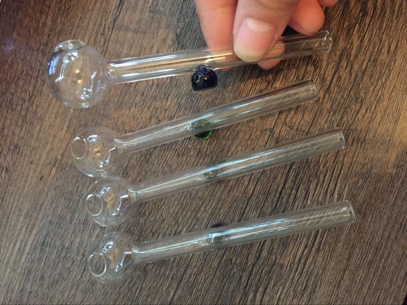 10ピースの安いガラスの水道管オイルバーナーの管のガラスの油管のための2cmの透明な手の喫煙パイプバランステーブル