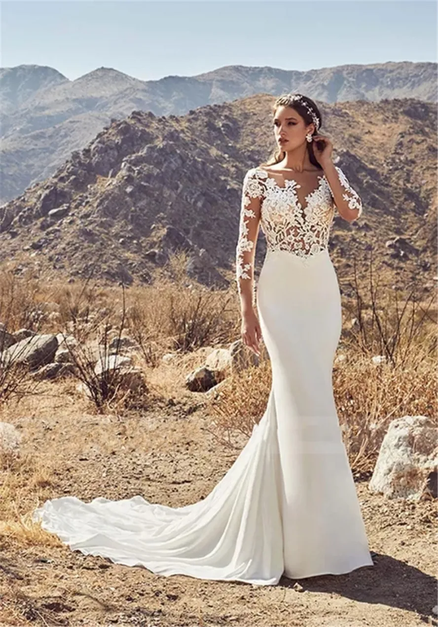 2020 Sheer Backless Mermaid Wedding Gown with Applique Detailing, Long Sleeves, and Open Back - Bridal Gown with Nude Bodice and Scoop Neckline -