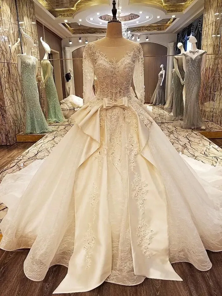 2019 New Arrival Luxurious Wedding Dresses Sheer Bateau Neck V Back Lace up Pearls Bead Appliques Bridal Gowns with Sheer Sleeves