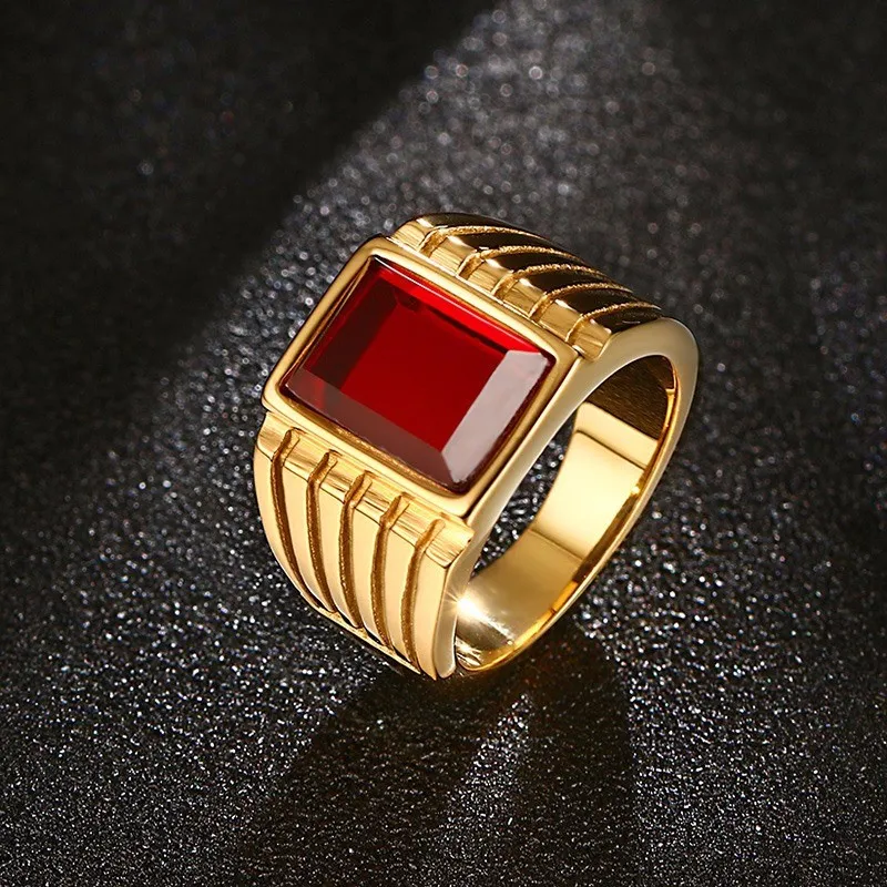 Premium Photo | A gold ring with a red gem and a garnet on it.
