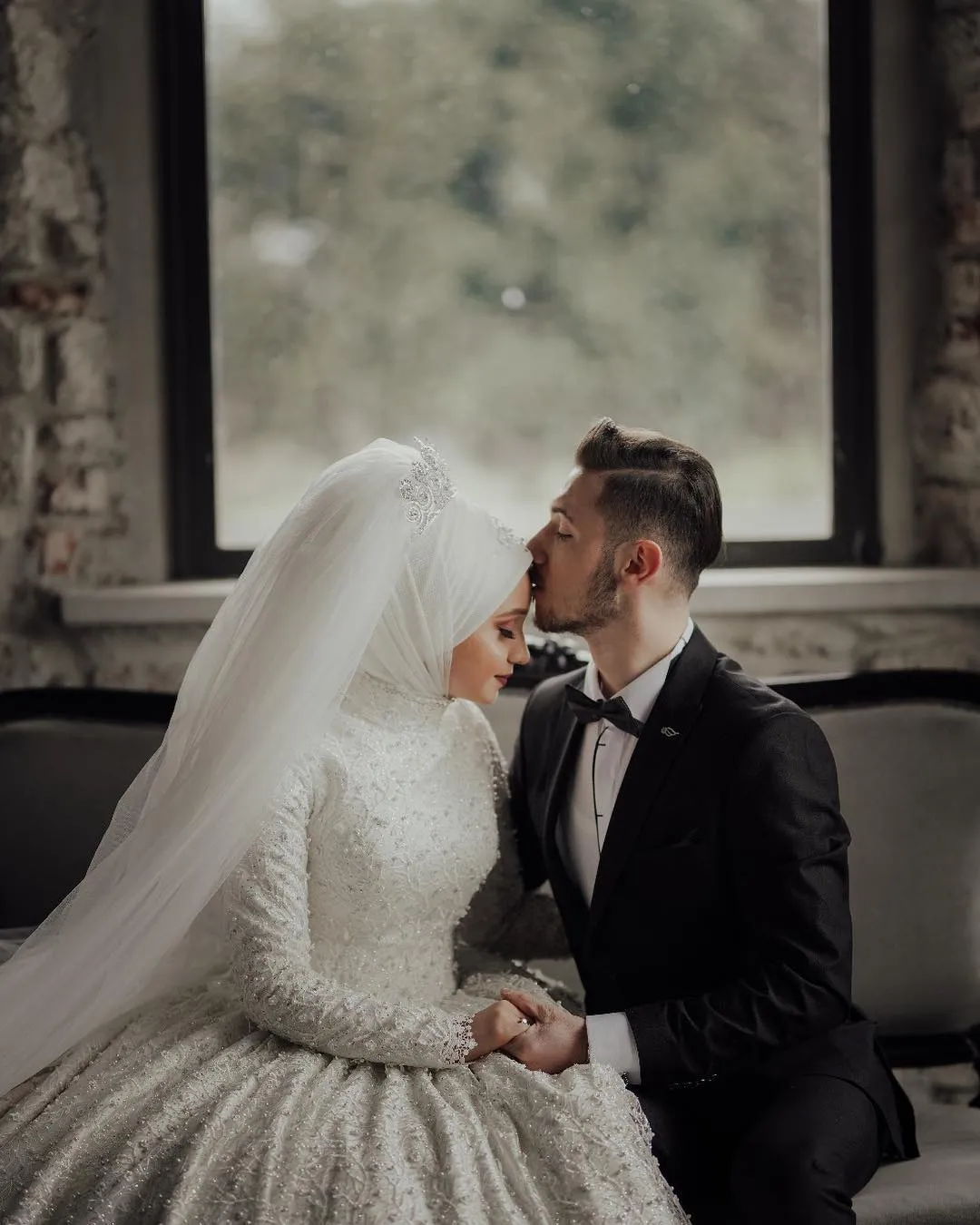 Beautiful Bride Posing in her Bridal Gown and Holding a Flower Bouquet ·  Free Stock Photo