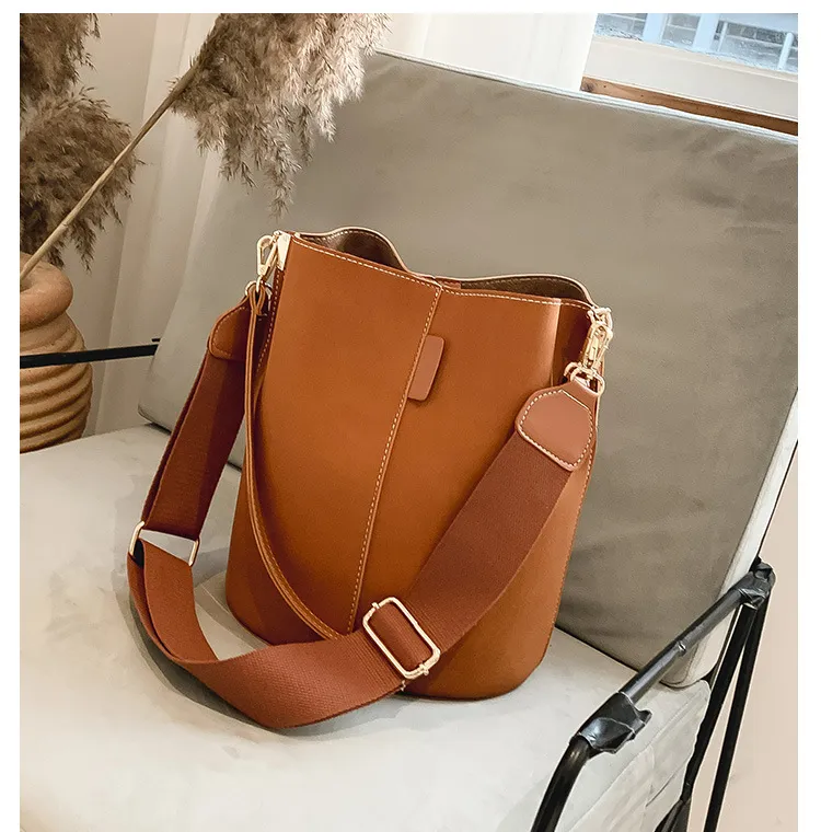 Purses with wide shoulder strap outlet