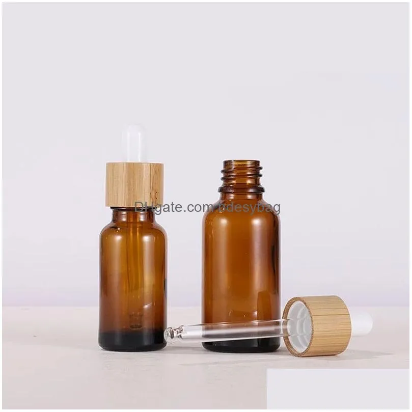 Packing Bottles Wholesale 30Ml 50Ml Clear Amber Glass Dropper Bottle With Bamboo Cap 1Oz Glasses Vials For Essential Oil Drop Delivery Dhig3