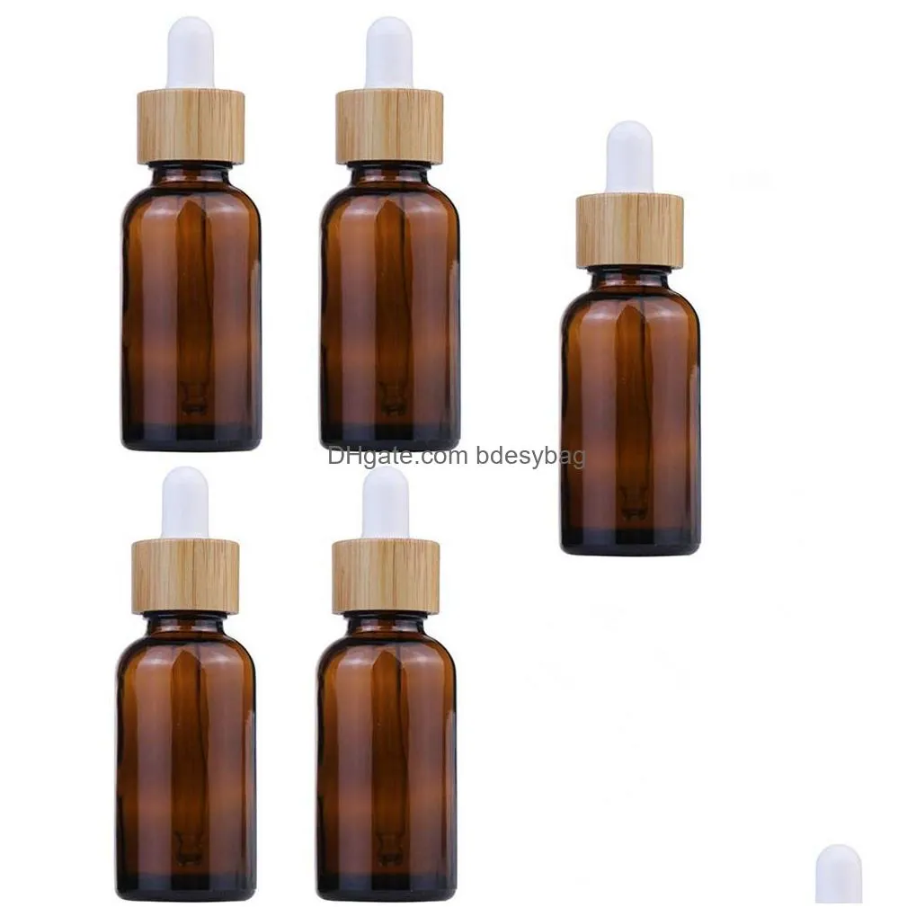 Packing Bottles Wholesale 30Ml 50Ml Clear Amber Glass Dropper Bottle With Bamboo Cap 1Oz Glasses Vials For Essential Oil Drop Delivery Dhig3