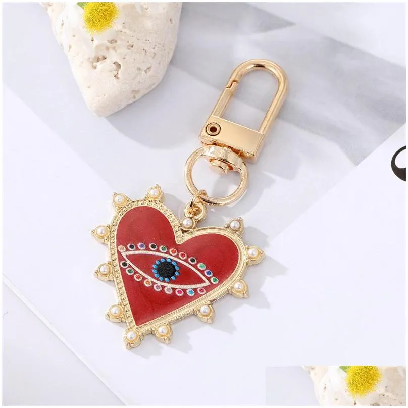 Keychains & Lanyards Rhinestones Pearl Evil Eyes Keychains Alloy Men Women Peach Love Heart Devils Bag Car Keychain Pendant In Bk Dro Dhuoz