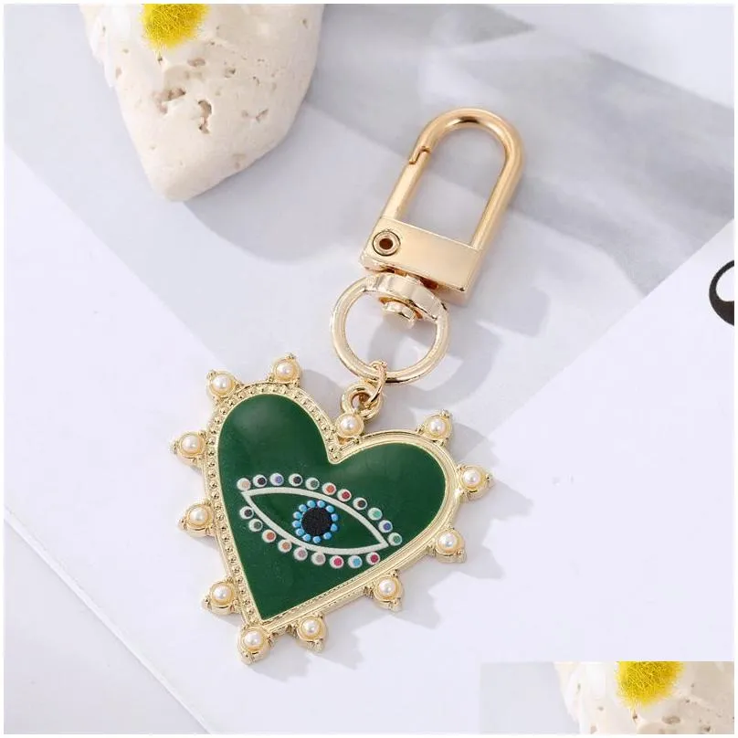 rhinestones pearl evil eyes keychains alloy men women peach love heart devils eyes bag car keychain pendant in bulk