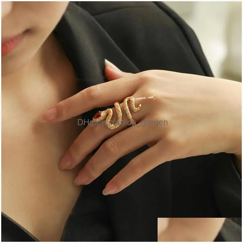 Womens Gold Ring with a Diamonds Fringe, with Stones in the Middle on Finger,  on a Black Background. Stock Image - Image of background, design: 145106649