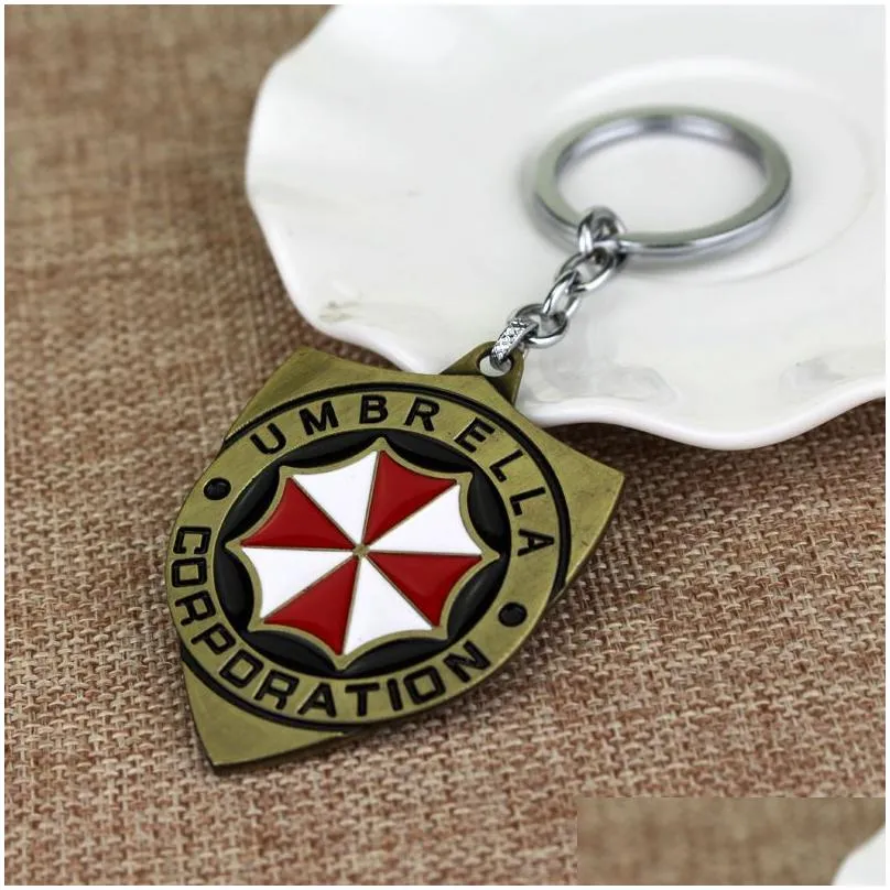 Keychains & Lanyards Resident Evil 2 Colors Alloy Keychain Umbrella Corporation Logo Shield Shape Hoder For Fans Unique Movie Jewelry Dhnyh