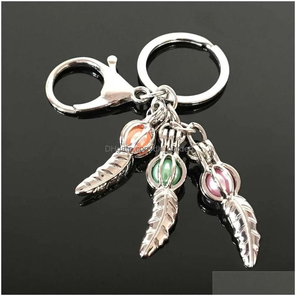 pearl cage key ring in europe and america can open keyring with hollow noctilucent volcanic stone pendant