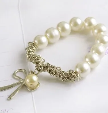 Venta caliente nueva moda hermosa perla arco nueva pulsera perla pulsera arco pulsera envío gratis con número de seguimiento