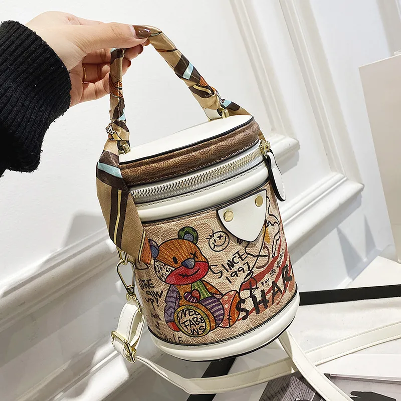 Wholesale ladies shoulder bags sweet cute bear graffiti bucket bag street trend cylinder women ribbon handbag European popular contrast leather backpack 7771