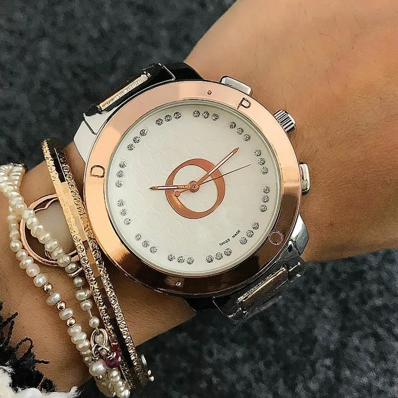 Marque de mode montres femmes dames fille cristal grandes lettres Style métal acier bande Quartz montre-bracelet cadeau populaire durable assez charmant