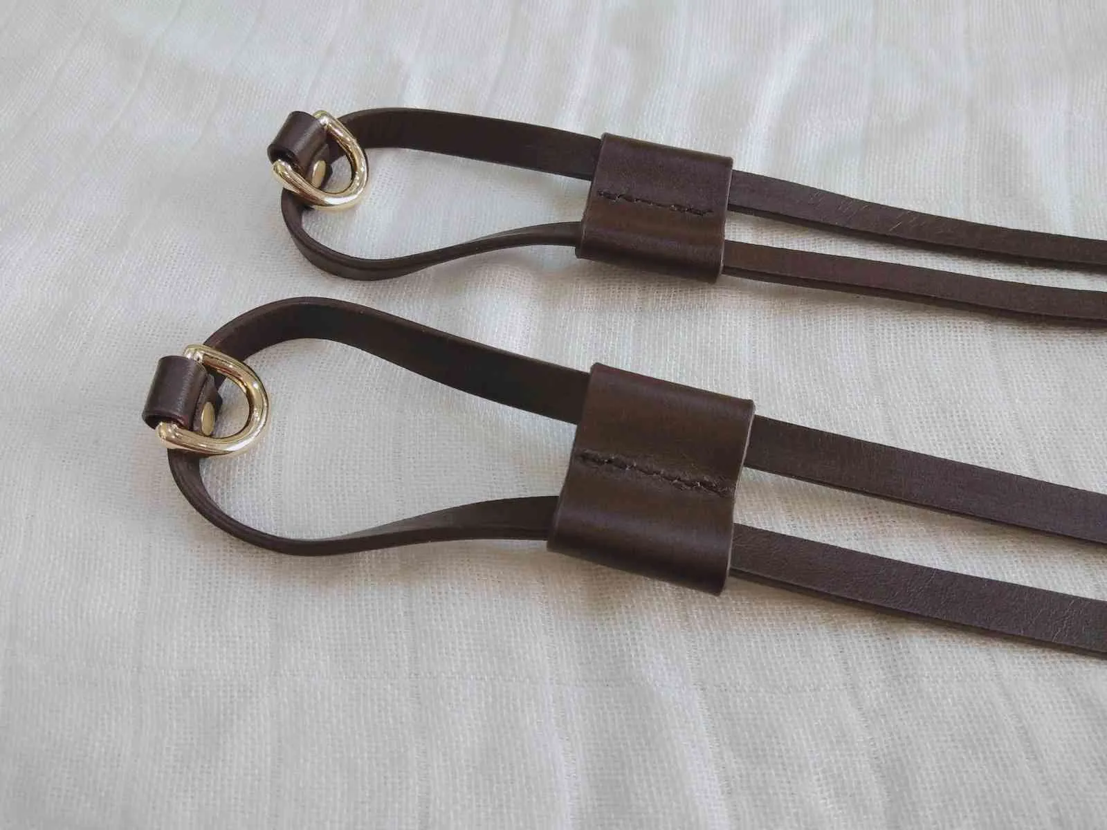 A pair of cinch drawstrings for luxury handbag ,real vachetta leather strap and slider