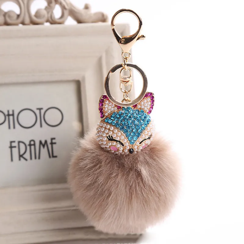 Fox päls head pompoms plysch boll keychain med konstgjord inlay pärla kristall rhinestone nyckel ring prydnad kvinna väska hänge dekor