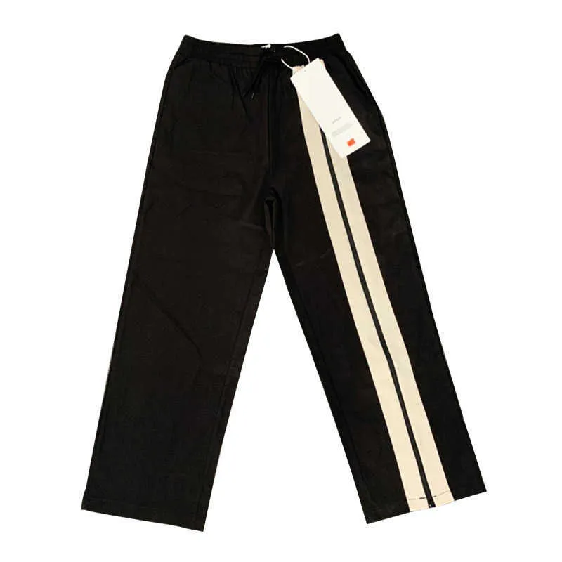 Pantaloni da uomo Apaig cuciture bianche e nere contrasto di colore cerniera diritta divisa tuta pantaloni casual a gamba larga a righe marchio di moda