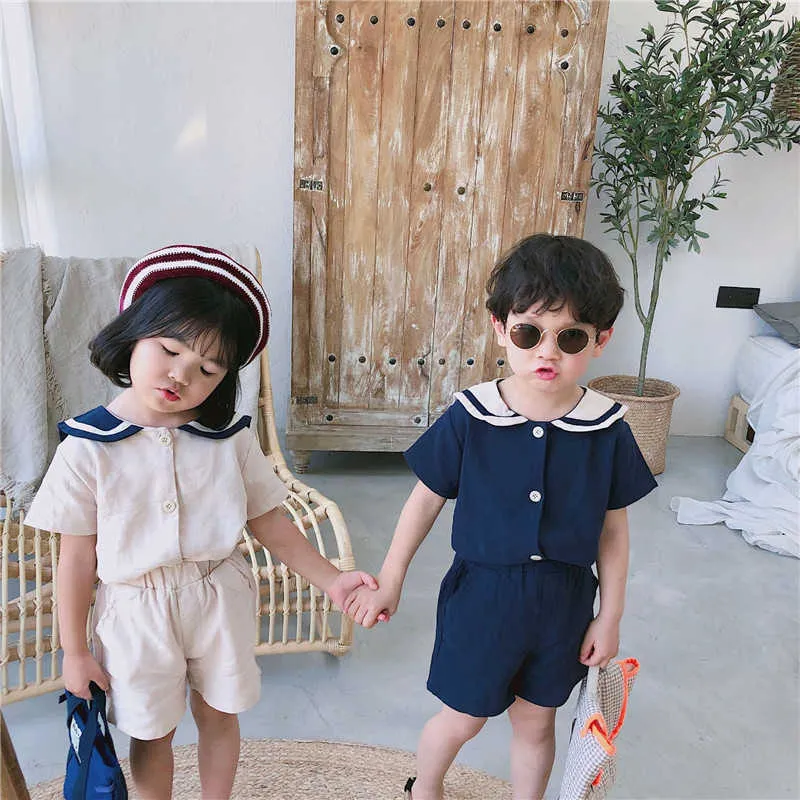 Sommar koreanska stil barn sjöman krage bomull linne kläder sätter söta pojkar flickor kortärmad t-shirt + shorts 2st satsar g003 210615