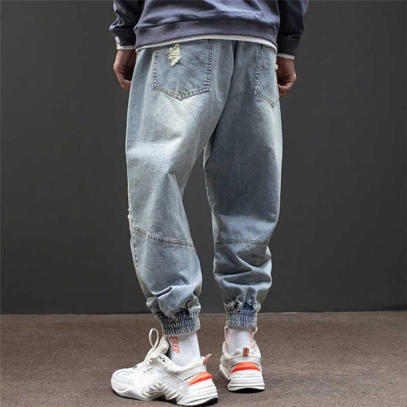 Hip-hop stil harem byxor män 2020 lösa jeans homme rippade frayed denim tvättade jeans streetwear utomhus fritid komfort sarouel x0621