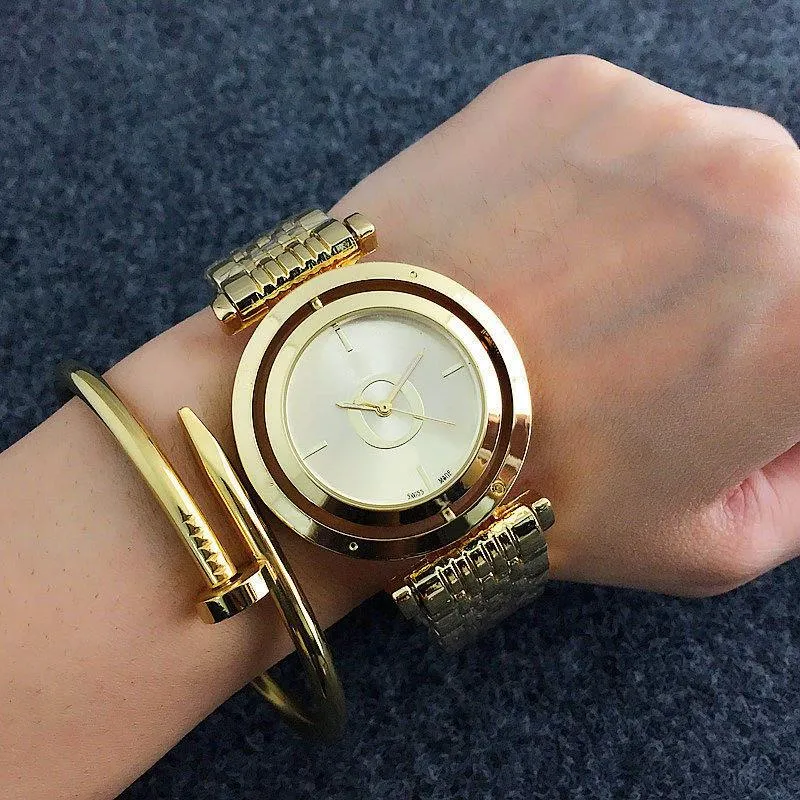 Мода бренд часы женщин дамы девушка хрусталь большие буквы вращающиеся стиль циферблат металла металлическая стальная полоса кварцевые наручные часы дизайнер подарок высококачественный красивая грация