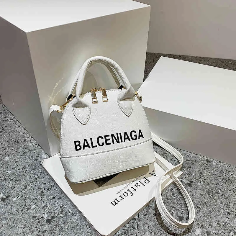 Bolso de mano bolsos de moda Shell para mujer un mensajero portátil pop cargo carta de gran capacidad color caramelo fábrica al por mayor 70% de descuento