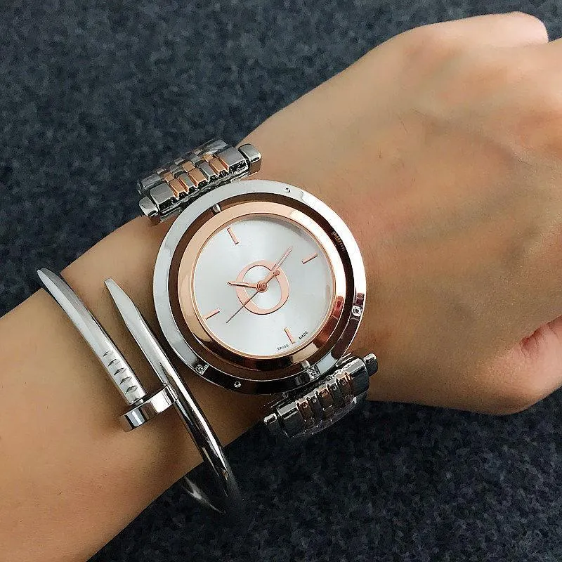 Мода бренд часы женщин дамы девушка хрусталь большие буквы вращающиеся стиль циферблат металла металлическая стальная полоса кварцевые наручные часы дизайнер подарок высококачественный красивая грация