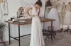 Boho bröllopsklänningar lihi hod 2018 Bohemiska brudklänningar med mössa ärmar och v hals veckad kjol elegant a-line brudklänningar låg rygg