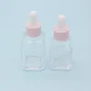 Frasco conta-gotas quadrado de óleo essencial de 20 ml Frascos de soro de vidro transparente de 30 ml com tampa rosa para cosméticos