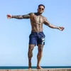 Fitness bodybuilding mens sommar casual cool kort byxor röd svart manlig jogger träning strand shorts för män