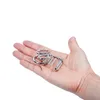 Anillos de rompecabezas chinos de Metal, conjunto de nueve anillos entrelazados, enlaces de tamaño Mini, juguetes educativos para niños, juego de mesa para niños y adultos, 8 unids/set DLH195