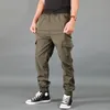 Pantaloni da uomo tinta unita caldi ispessiti casual esercito multi-tasche stile moda pantaloni da lavoro cargo tuta