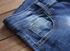 Męskie Dżinsy Europa i Ameryka Slim Prosta Elastyczna Łatka Odznaka Otwory Gorąca Sprzedaż Męskie Spodnie Duży Rozmiar