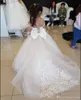 Schöne Prinzessin Elfenbein Blumenmädchenkleider Spitze mit langen Ärmeln Sheer Ausschnitt Appliques Kind-Kleinkind-Kleid für Hochzeit-Geburtstags-Party mit Bogen