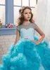 Nuovi abiti economici per ragazze di fiori per la cerimonia nuziale Blush Pink Ball Gown Cap maniche Tulle Ruffles Tiered Beaded Children Kids Party Abiti da comunione