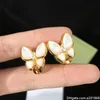 Squisiti orecchini a farfalla con conchiglia in oro e bianco0123453624902